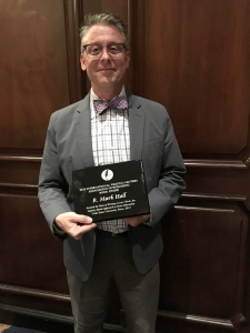Dr. Mark Hall accepts his International Writing Center Association award for Outstanding Book/Major Work of 2018.
