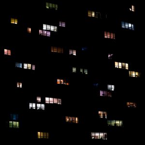 Photographic artwork created by Clarissa Bonet, this image shows a collection of illuminated windows at night.