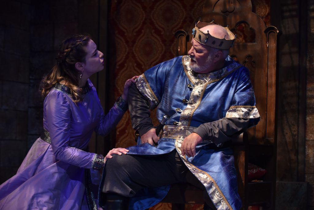 Mark Brotherton performs with a student in Lion in Winter dressed as a king.