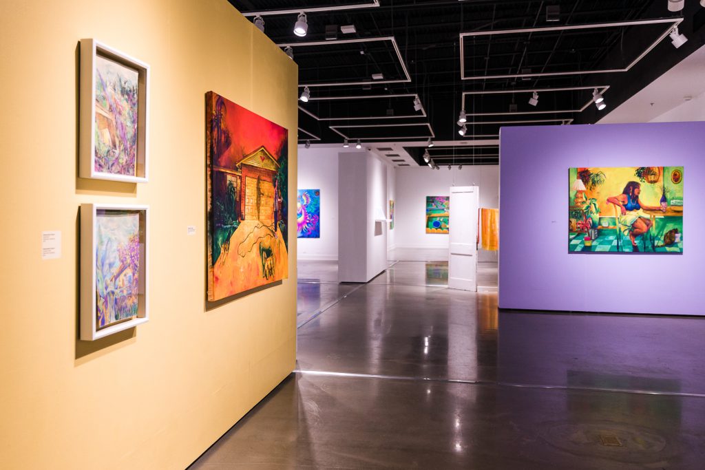 Artwork on multiple colored gallery walls during the 2022 MFA Exhibition: Florida Room.