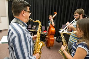 Faculty and staff play their instruments
