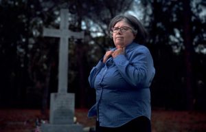 Barbara Gannon stands near a granite monument to the Olustee battleground
