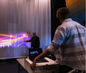 Student and professor work on projector and screen