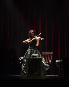 Iryna Usova, Ukranian violinist, performs on stage.